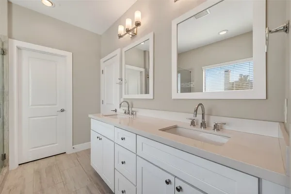 a bathroom with a double vanity sink mirror and