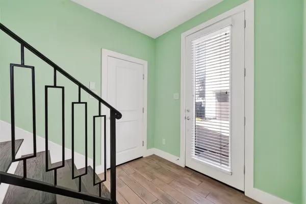 a view of an entryway with wooden floor