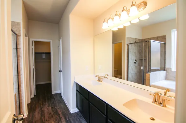 a bathroom with a double vanity sink and a mirror