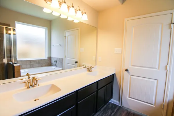 a bathroom with a double vanity sink and a mirror
