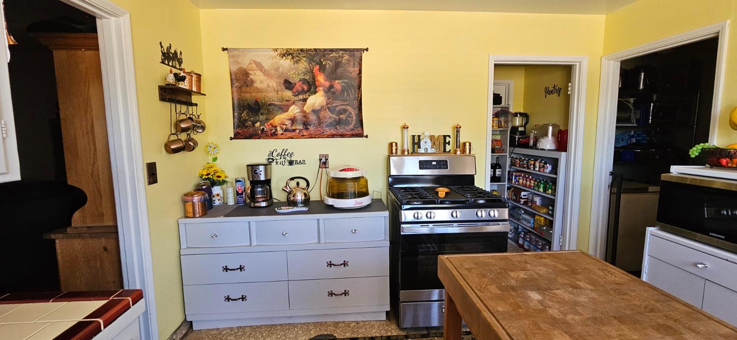 20822 Disch Road Lockeford, CA 95237 - Photo 9 of 30 a kitchen with a refrigerator and a stove