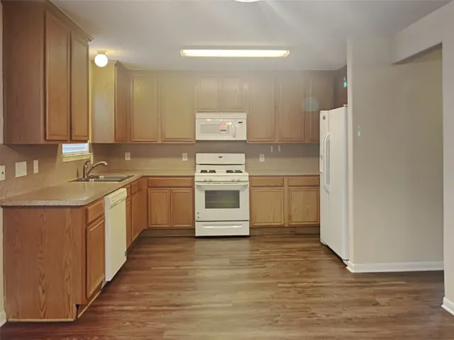a kitchen with stainless steel appliances a stove a sink and white cabinets
