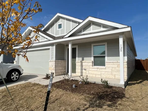 a front view of a house with parking space