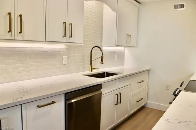 a view with cabinets a sink and dishwasher in it