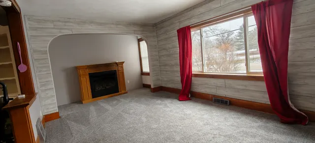 a kitchen with a refrigerator and cabinets