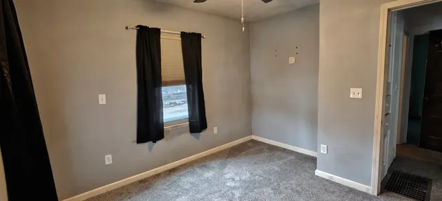a view of a kitchen with cabinets and stainless steel appliances