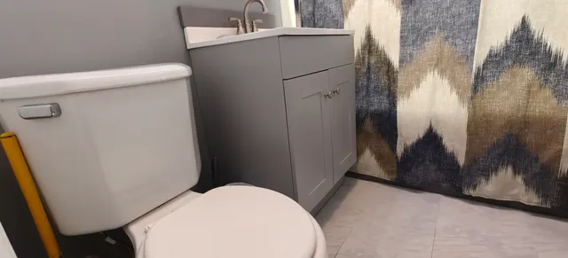 a bathroom with a sink a toilet and a mirror