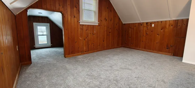 a view of a room that has a bed and a window