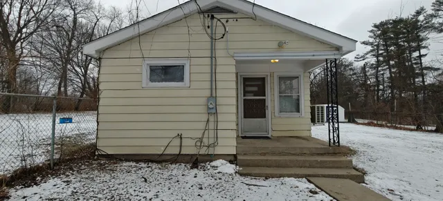 a white toilet sitting next to a sink and vanity