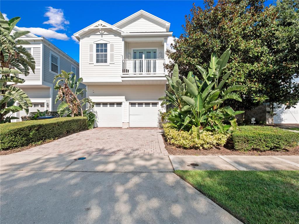 7734 Linkside Loop Reunion, FL 34747 - Photo 1 of 1 a front view of a house with a yard and potted plants