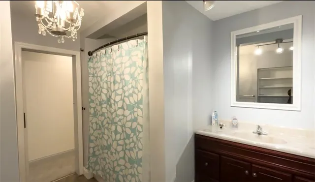 a bathroom with a sink a mirror and a shower