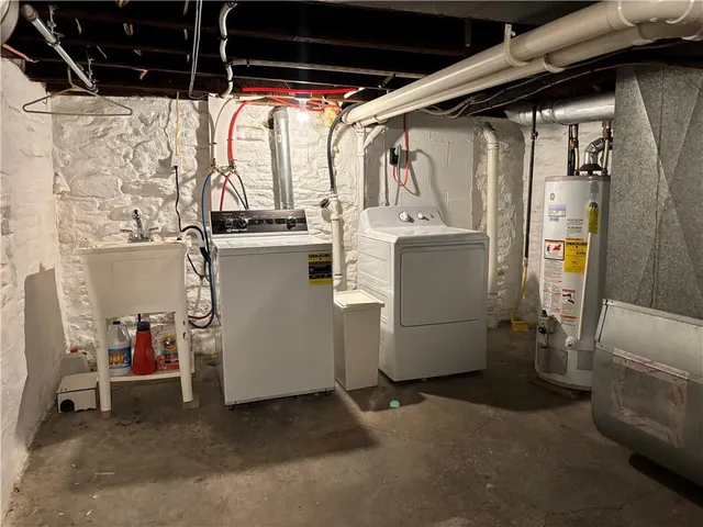 a view of storage and utility room with washer and dryer