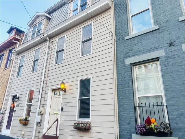 a view of a house with a door and furniture