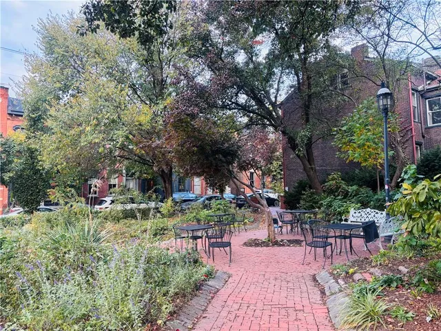 a backyard of a house with table and chairs