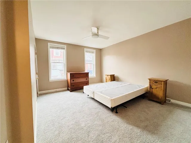 a bedroom with a bed and a desk