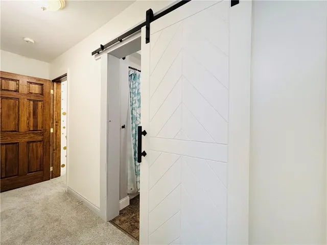 a bathroom with a shower and a glass door