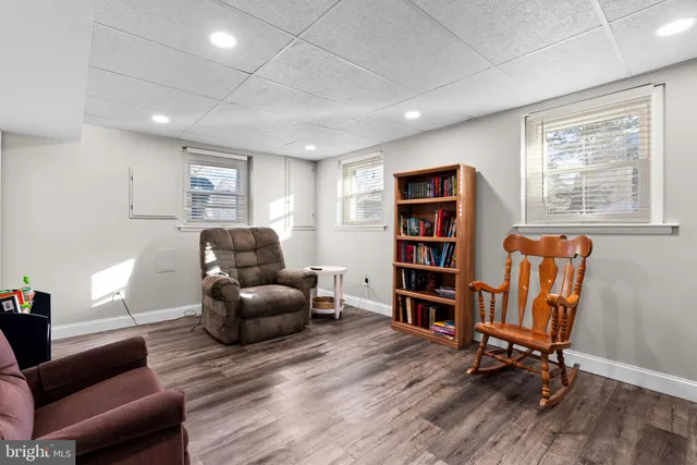 a living room with furniture and a book shelf