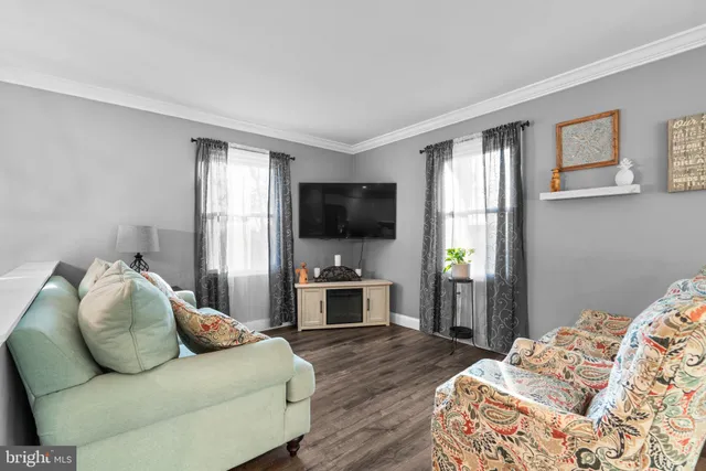 a bedroom with furniture and a flat screen tv