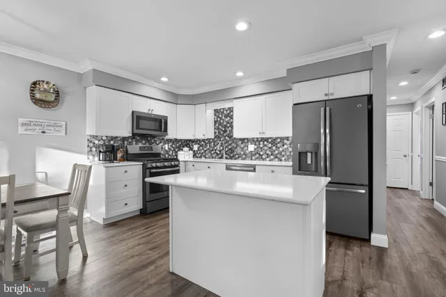 a kitchen with stainless steel appliances a refrigerator stove microwave and cabinets