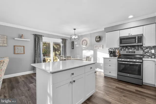 a kitchen with stainless steel appliances granite countertop a stove and cabinets