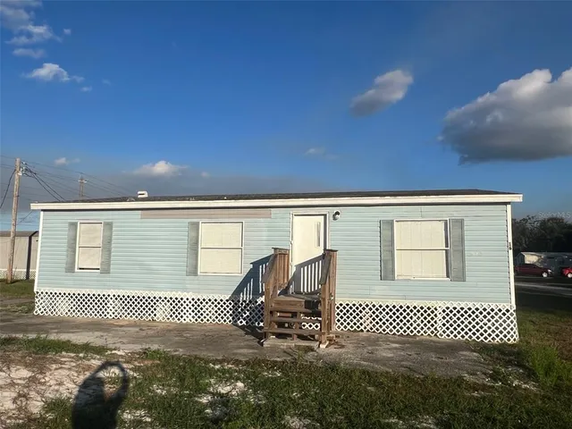 a kitchen with a sink a stove a microwave and a refrigerator
