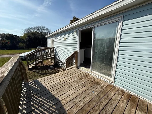 a view of kitchen with microwave stove refrigerator and cabinets