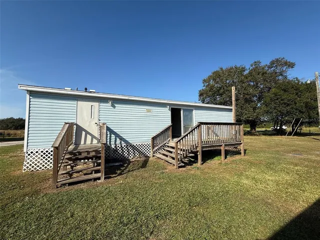 a view of a big room with wooden floor and windows