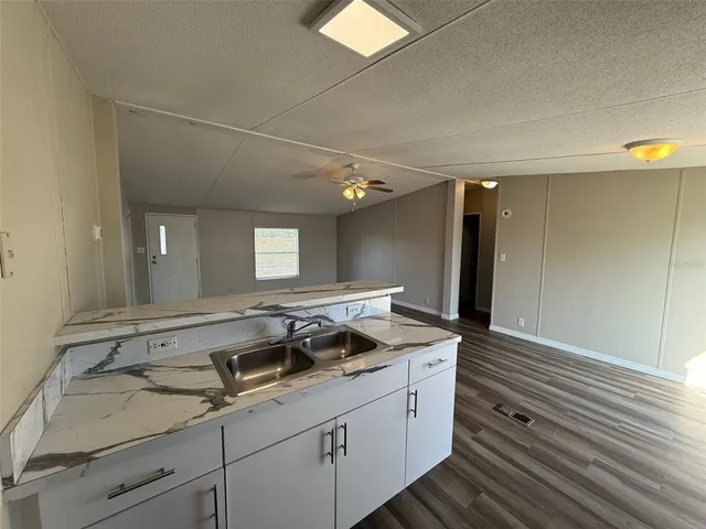 a kitchen with a sink stove and refrigerator