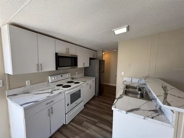 a view of kitchen with cabinets and wooden floor