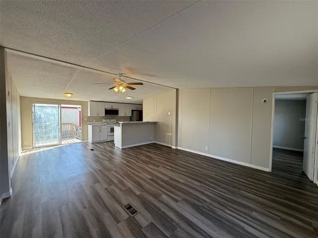 a view of a kitchen with a sink and a window