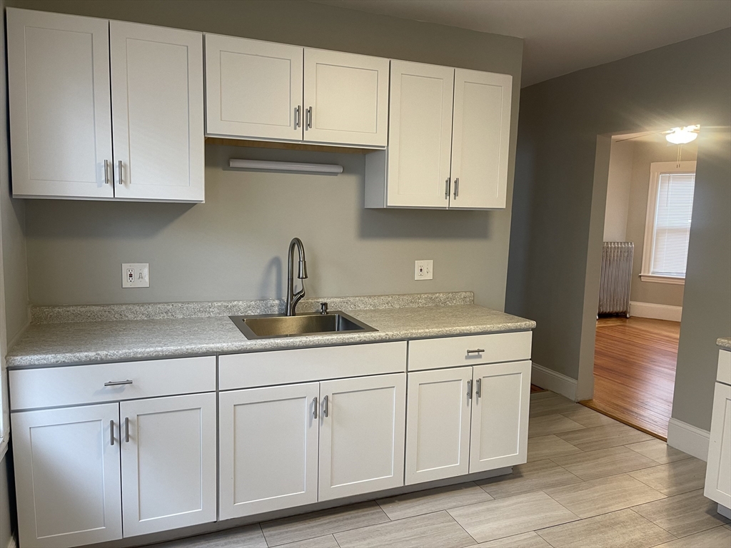 25-27 Spaulding Street, Unit 2 Boston, MA 02122 - Photo 1 of 14 a kitchen with white cabinets