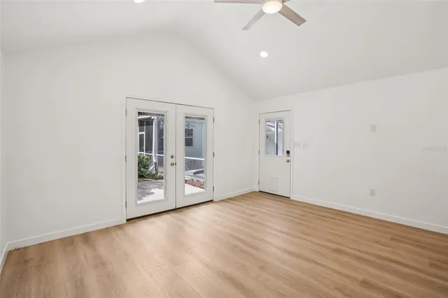 an empty room with fan and windows