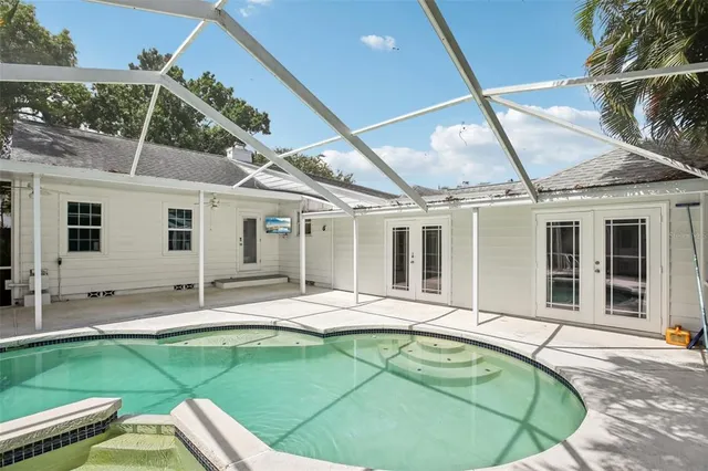 a view of a house with pool in front of it