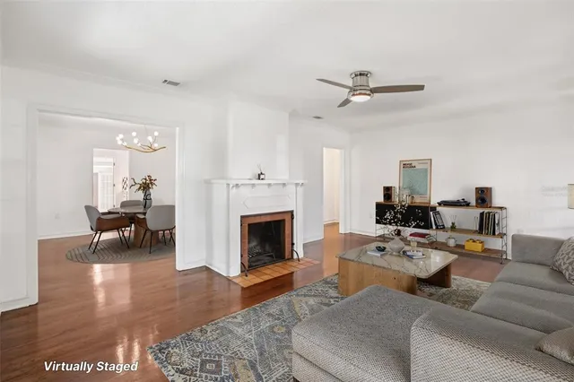 a living room with furniture a fireplace and a table