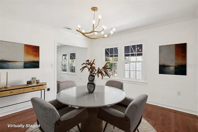 a view of a dining room with furniture and wooden floor