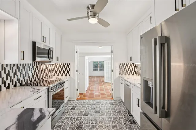 a hallway with cabinets and wooden floor