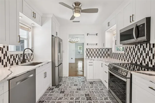 a kitchen with a sink stove and refrigerator