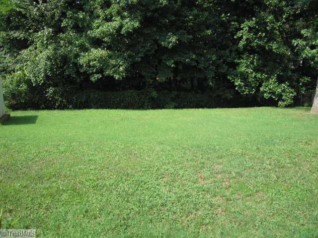 1906 Three Meadows Road Greensboro, NC 27455 - Photo 10 of 10 Exterior Back. Fabulous fenced yard with great deck, patio area AND storage unit!