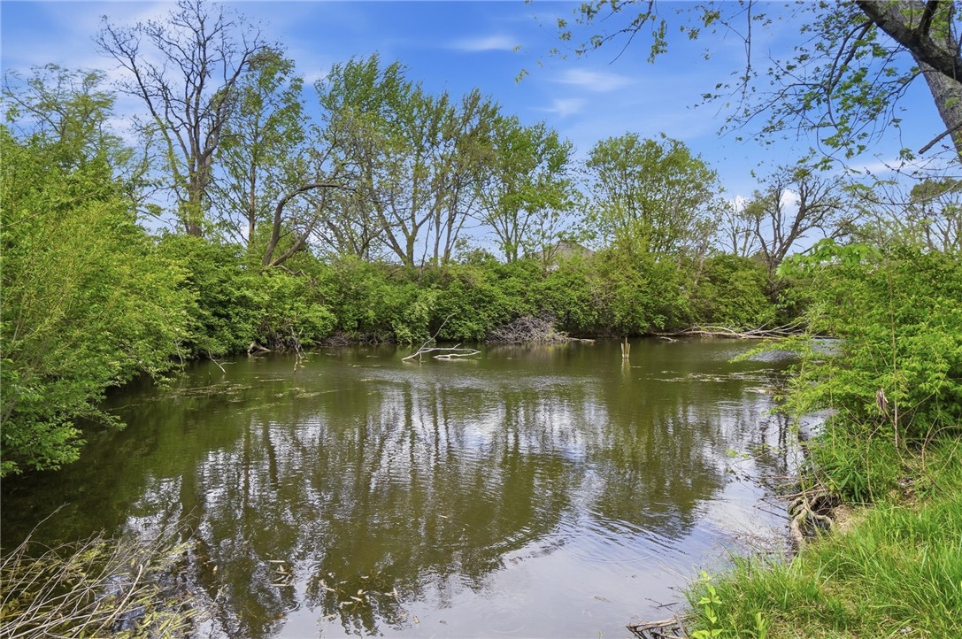 3991 Benner Road Miamisburg, OH 45342 - Photo 44 of 44 This tranquil waterfront setting offers a serene escape, surrounded by lush natural foliage and calm water.
