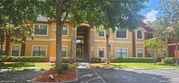 front view of a brick house with a yard