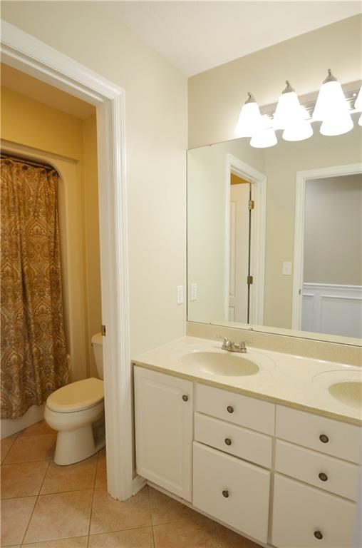 603 Heritage Place Cranberry Township, PA 16066 - Photo 19 of 25 a bathroom with a double vanity sink a toilet and a mirror
