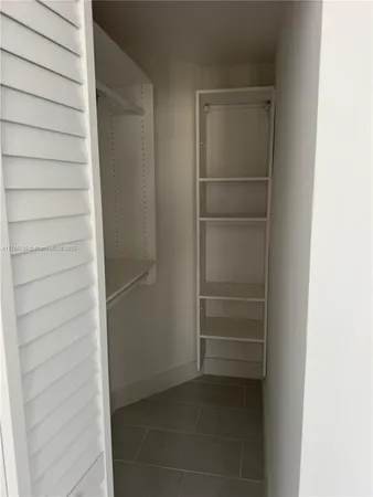 a view of closet area with empty racks