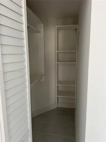 a view of closet area with empty racks