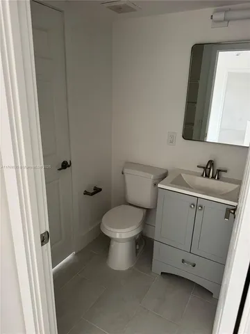 a white toilet sitting next to a bathroom sink