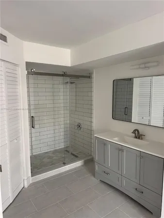 a bathroom with a bathtub a shower a sink and mirror