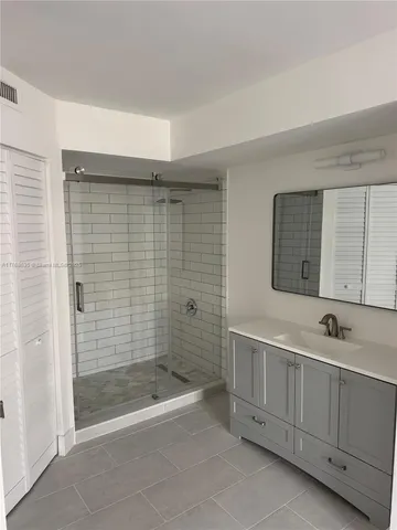 a bathroom with a bathtub a shower a sink and mirror
