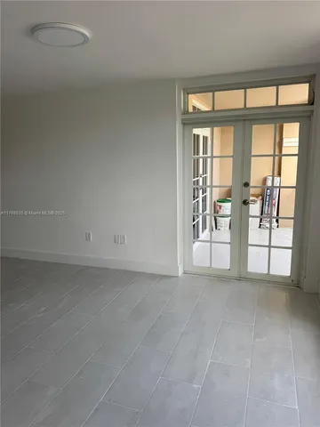 a view of an empty room with glass door