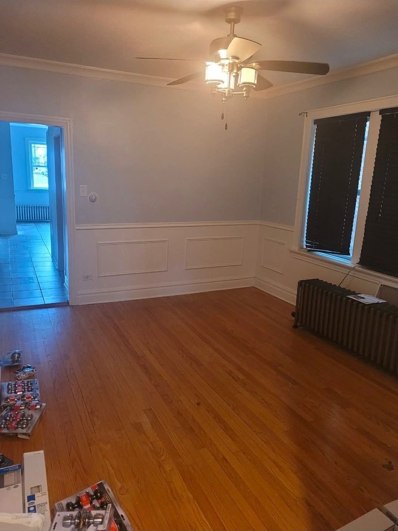 1630 Home Avenue, Unit 2 Berwyn, IL 60402 - Photo 2 of 7 a view of a livingroom with hardwood floor and a ceiling fan
