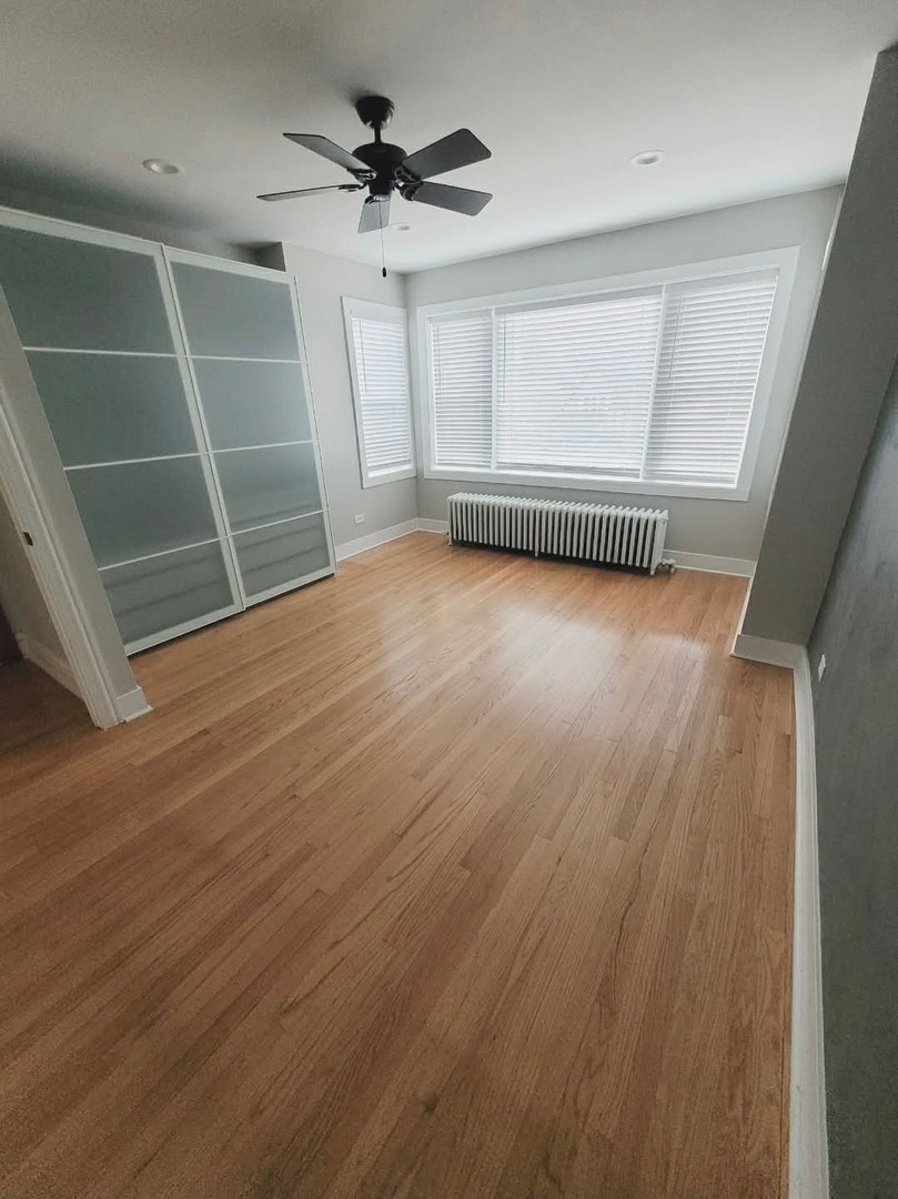 1630 Home Avenue, Unit 2 Berwyn, IL 60402 - Photo 6 of 7 an empty room with wooden floor and windows