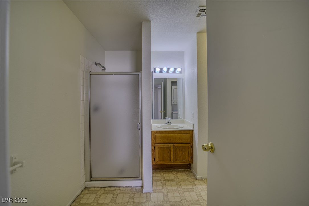 2232 Aspen Mirror Way, Unit 202 Laughlin, NV 89029 - Photo 17 of 39 Full bath featuring vanity, a stall shower, and light flooring